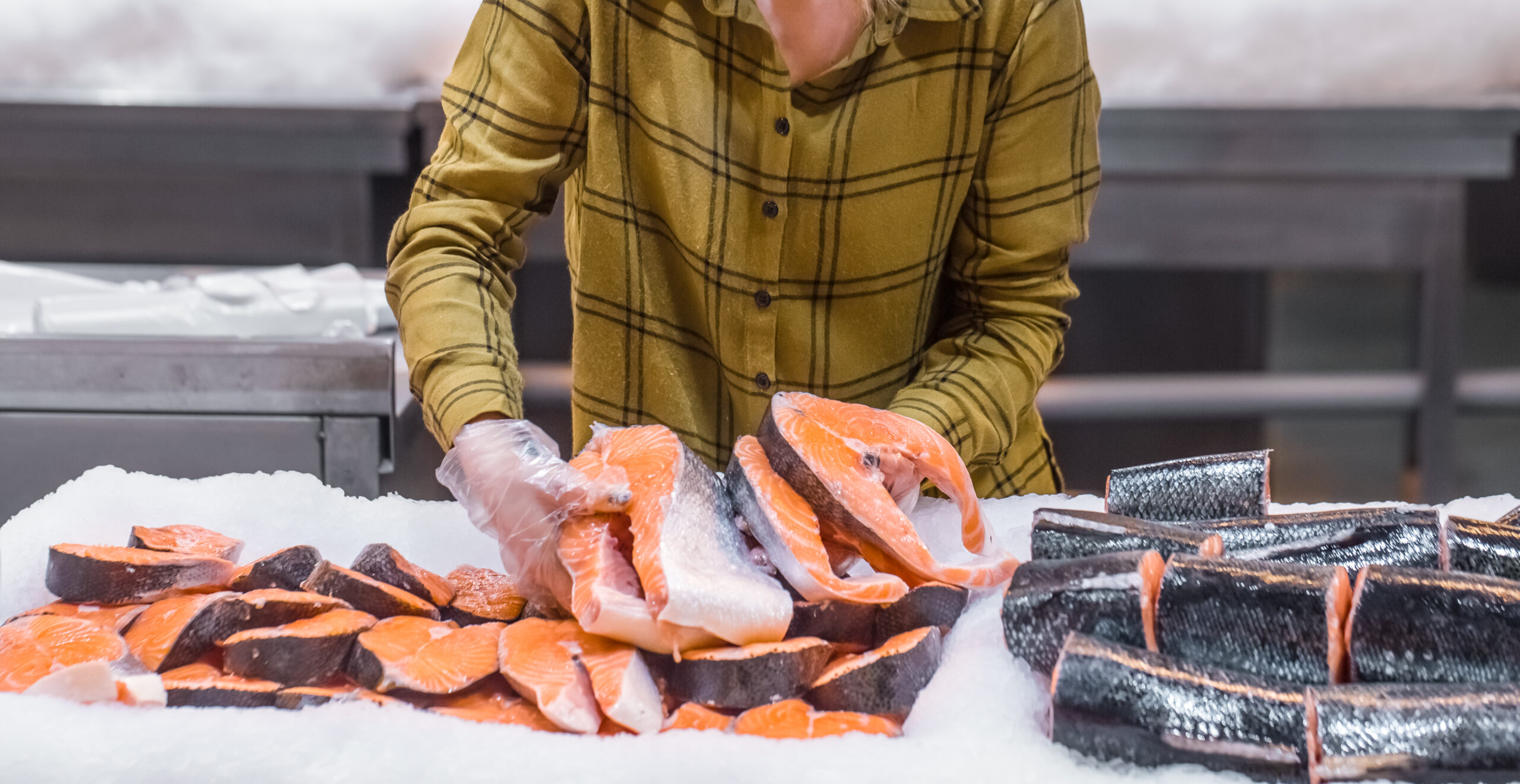 woman in the supermarket beautiful young woman holding salmon fish in her hands scaled